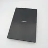 A black Canon scanner is shown from a top-down diagonal angle on a white background. Produktbild-Vorschau