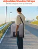 A person walks down a paved path carrying a gray bag over their shoulder. Produktbild-Vorschau