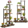Two multi-tiered plant stands filled with various potted plants. Náhled obrázku produktu