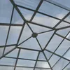 A close-up view of the transparent roof of a garden pavilion, showing the geometric frame structure and the sky through the panels. Náhled obrázku produktu