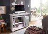 A white computer desk with a monitor, keyboard, and PC tower is set up in a room with a window overlooking a garden. Podgląd zdjęcia produktu