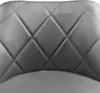 A close-up view of the quilted upholstery of a gray bar stool. Produktbild-Vorschau