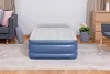 An inflatable air mattress is shown in a living room setting, placed on a rug. Produktbild-Vorschau