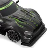 Close-up view of the front of a black remote-controlled drift car with green racing stripes and accents. Produktbild-Vorschau