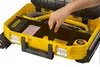 A hand is shown organizing tools inside a yellow Stanley FatMax tool case. Voir les images du produit