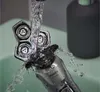 A close-up shot of a Philips electric shaver being rinsed under running water in a sink. Náhled obrázku produktu