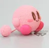 A crocheted Kirby figurine is shown sitting on a light gray surface, with a smaller crocheted ball to its left. Produktbild-Vorschau