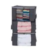 Three gray storage bags stacked vertically, filled with folded clothes, pink comforters, and white bedding. Produktbild-Vorschau