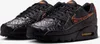 A pair of black Nike Air Max 90 sneakers with orange accents and a unique textured pattern. Anteprima dell’immagine prodotto