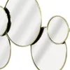 A close-up view of a decorative mirror with multiple circular and semi-circular mirrored elements, framed in gold. Podgląd zdjęcia produktu