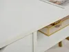 A close-up view of a white desk with a drawer and a shelf. A decorative box with gold trim is visible on the shelf. Voir les images du produit