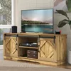 A TV stand with a television and other electronic devices in a living room setting. Anteprima dell’immagine prodotto