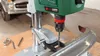A drill press is shown drilling into a car bumper. Podgląd zdjęcia produktu