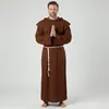 A man wearing a monk costume stands with his hands clasped in prayer. Náhled obrázku produktu