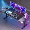 A gaming desk setup with dual monitors, keyboard, mouse, and gaming console, illuminated by LED lighting. Voir les images du produit