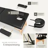 A black massage table with various accessories and labels indicating features. Produktbild-Vorschau