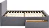 A side view of a grey upholstered bed frame with a headboard and two drawers partially open, revealing wooden slats and drawer interiors. Produktbild-Vorschau