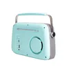 A rear-view of a mint-colored vintage-style Bluetooth radio with a silver handle and a gray side panel. Náhled obrázku produktu