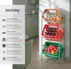 A three-tiered storage rack for drink crates, filled with bottles and fruit, is shown in a kitchen setting. Náhled obrázku produktu