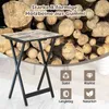 A folding table with a wood-like top and black metal legs is shown in front of a pile of firewood. There are also four icons with text below them. Produktbild-Vorschau