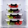 Four glass food storage containers stacked inside a refrigerator. Náhled obrázku produktu
