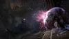 A scene from a video game showing characters casting spells in a dark, ancient-looking environment. Produktbild-Vorschau