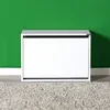 A white shoe cabinet against a green wall and a textured rug. Podgląd zdjęcia produktu