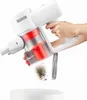 A hand is holding a white and red cordless vacuum cleaner, emptying dust into a white container. Produktbild-Vorschau