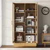 A tall wooden cabinet with glass doors and shelves filled with books and decorative items, placed in a room with a clock on the wall. Podgląd zdjęcia produktu