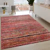 A living room with a rug, a cabinet, and a window overlooking a city. Produktbild-Vorschau