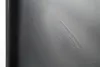 A close-up view of a scratch or scuff mark on a dark gray surface, possibly a table or furniture. Produktbild-Vorschau