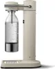 A sand-colored AARKE Wassersprudler Carbonator 3 with a PET bottle filled with water. Produktbild-Vorschau