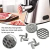 A close-up view of a meat grinder with minced meat, along with its accessories. Produktbild-Vorschau