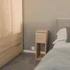 A bedroom scene with a nightstand next to a bed and a wardrobe. Produktbild-Vorschau