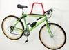 A green bicycle is mounted on a wall using a red and black bike rack. Produktbild-Vorschau