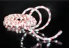A coiled candy cane-striped light string on a black reflective surface. Produktbild-Vorschau