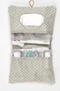 A hanging organizer bag with a mirror and compartments, containing baby items like diapers and creams. Produktbild-Vorschau