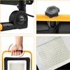 Collage of close-up shots of a work light, showing its adjustable joints, a knob for adjustment, a hand holding the handle, and the LED panel. Produktbild-Vorschau