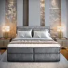 A luxurious bedroom with a large bed, bedside tables, and lamps. Produktbild-Vorschau