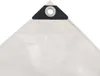 A close-up view of the corner of a white tarp with a black reinforced grommet. Náhled obrázku produktu