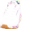 A close-up, front-facing view of a white SKECHERS sneaker with colorful graffiti-style designs on the sole and heel. Náhled obrázku produktu