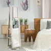A bedroom scene with a full-length mirror, bed, and decorative elements. Voir les images du produit