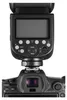 A close-up, top-down view of a camera flash unit mounted on a camera. Podgląd zdjęcia produktu