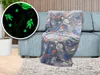 A glow-in-the-dark space-themed blanket draped over a sofa. Náhled obrázku produktu