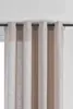 A close-up view of a curtain hanging from a curtain rod. Produktbild-Vorschau