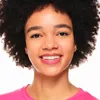 A close-up portrait of a young woman smiling. Podgląd zdjęcia produktu