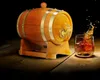 A wooden barrel with a tap, next to a glass of whiskey with a splash. Náhled obrázku produktu