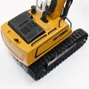 A close-up, top-down view of a yellow toy excavator. Náhľad obrázku produktu