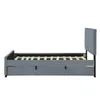 A side view of a grey upholstered bed frame with a slatted mattress base and a pull-out trundle bed underneath. Náhled obrázku produktu