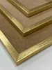 A close-up view of stacked gold picture frames. Voir les images du produit